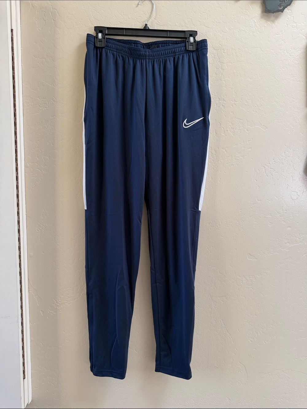 Nike Navy Track Pants with White Swoosh and Side Stripes